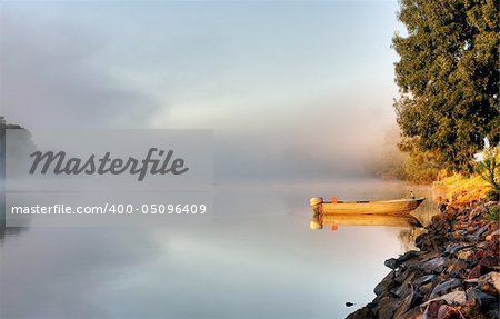 Shrouded by mist a secured boat on the Bellinger River at dawn