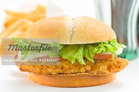 crisp chicken burger with tomato onion cheese lettuce isolated