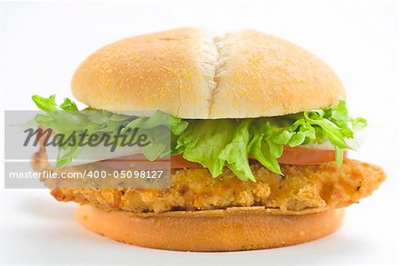 crisp chicken burger with tomato onion cheese lettuce isolated