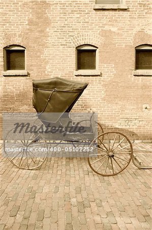 An old horse-drawn carriage done in sepia.