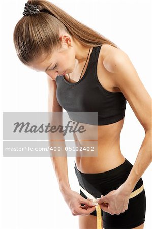 Young athletic girl measuring hips, isolated