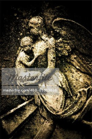 A stone carving of an angel mother and child