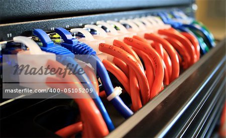 Closeup of ethernet network cables plugged into a server room switch.