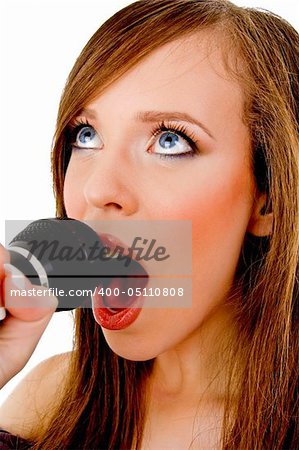 close view of woman singing into karaoke against white background