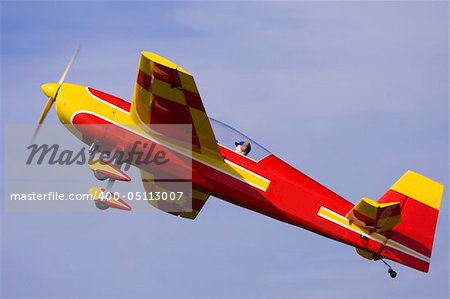A close up shot of a R/C model airplane performing stunts