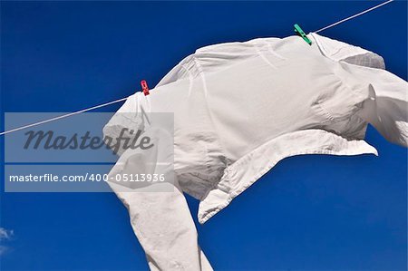 White shirt hanging to dry on clothes line