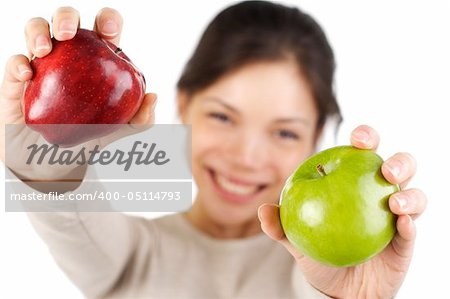 Beautiful smiling young woman presenting 2 apples, red and green. Isolated on white.