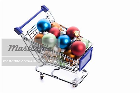 shopping cart full with colorfull christmas balls isolated on white background