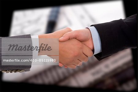 businesswoman handshake. signed contract in background.