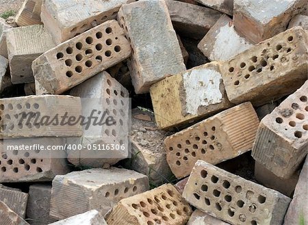 Many dirty bricks in a big pile