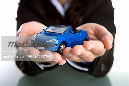 businesswoman holding car in the hands - insurance or car business concept