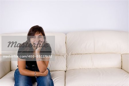 beautiful young woman with black shirt sitting in white sofa