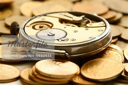 time is money coins and clock macro concept