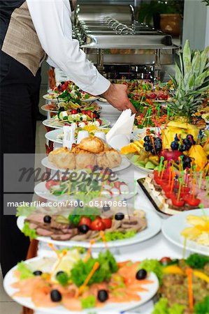 rich served banquet table with a lot of delicious dishes