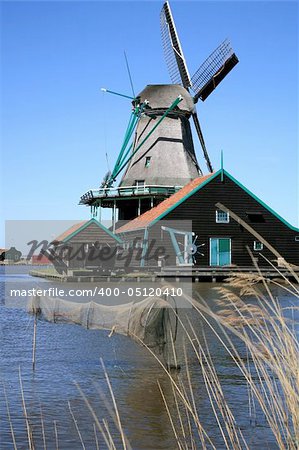 Famous picturesque Zaanse Schans in Netherlands. Group of historic old windmills .