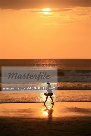 Beautiful sunset sky at summer evening with a silhouette of the woman. Bali. Indonesia