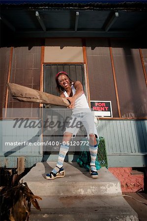 African American woman swinging a board on her front porch