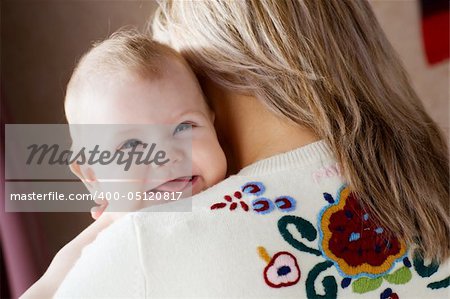 happy child on the shoulder of his mom