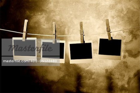 classic old polaroid photo Held By Clothespins with grunge background