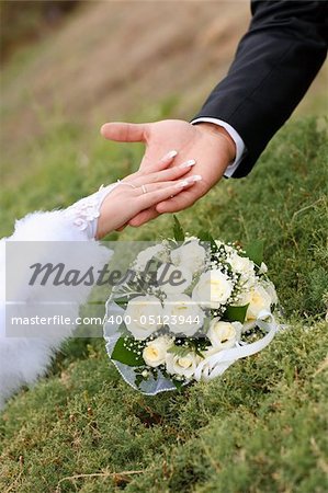 two hands over flower bouquet