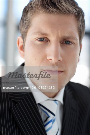 Attractive businessman looking at camera