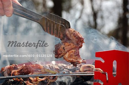 spoon taking a slice of grilled meat
