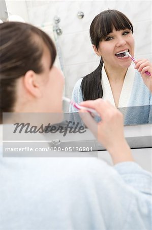 happy brunette woman in bathroom at morning