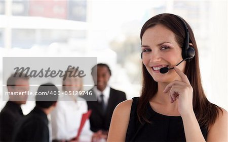 Young attractive woman talking on a headset in Office