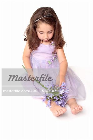 Little girl playing with a flower - above view
