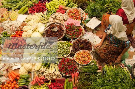 Muslim woman selling fresh vegetables at market in Kota Bharu Malaysia.