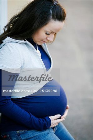 A young pregnant women spending time outdoors.