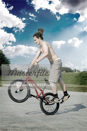 Extreme bicycle rider performing freestyle tricks on his bike.