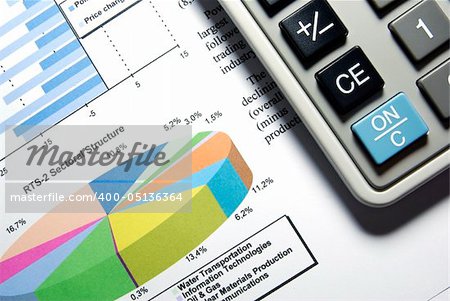 Calculator and printed stock data with diagrams.