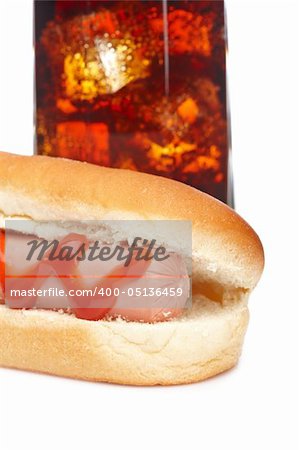 A hot dog and soda glass isolated on white background. Shallow depth of field