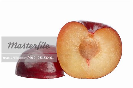 Two halfs fresh plums isolated on white background