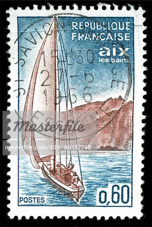vintage french stamp depicting a sailing yacht sailing along a coastline