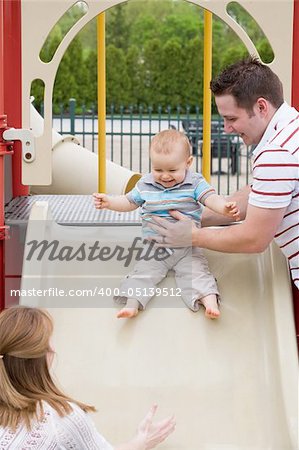 Baby Sliding Down Slide with Parents