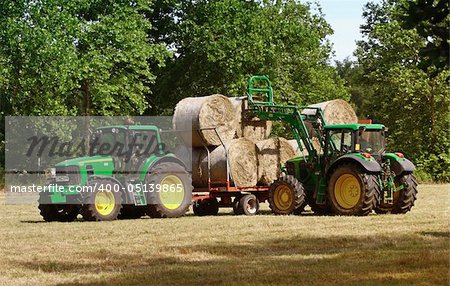 green tractor at work in field rural scene