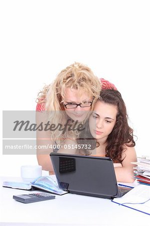 Woman helping young girl with laptop do homework