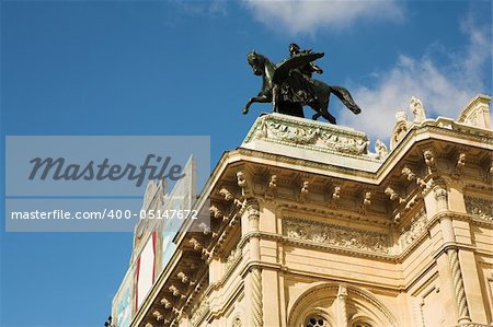 Statue of a man on top of horse on a roof of building in Vienna, Austria