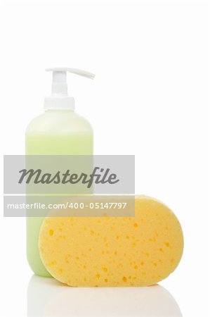 Plastic pump soap bottle and sponge reflected on white background