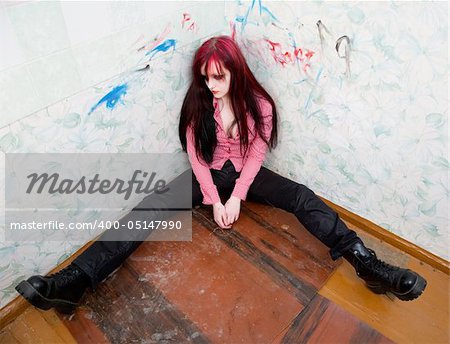 Young drunken woman lies in a corner