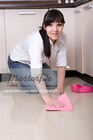 young brunette woman cleaning kitchen