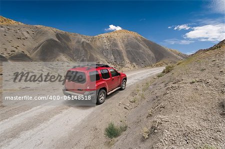 SUV driving the Cottonwood Canyon Road in Grand Staircase Escalante National Park, Utah