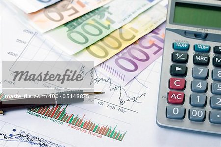 Closeup of a stock chart with Euro banknotes, calculator and pen