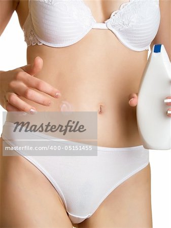 Woman applying creme to her stomach