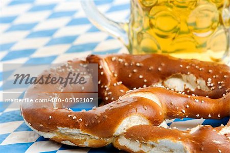 Close-up of one Bavarian Oktoberfest pretzel with beer stein (mug)