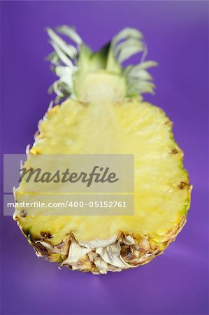 Pineapple with selective focus over purple background