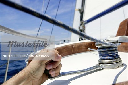 Blue summer water and sky in a sailboat race, sailor man in winch