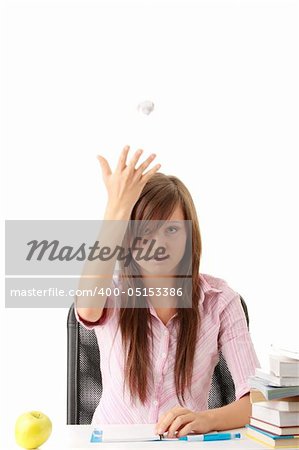 Teenage girl studying with textbooks looking unhappy